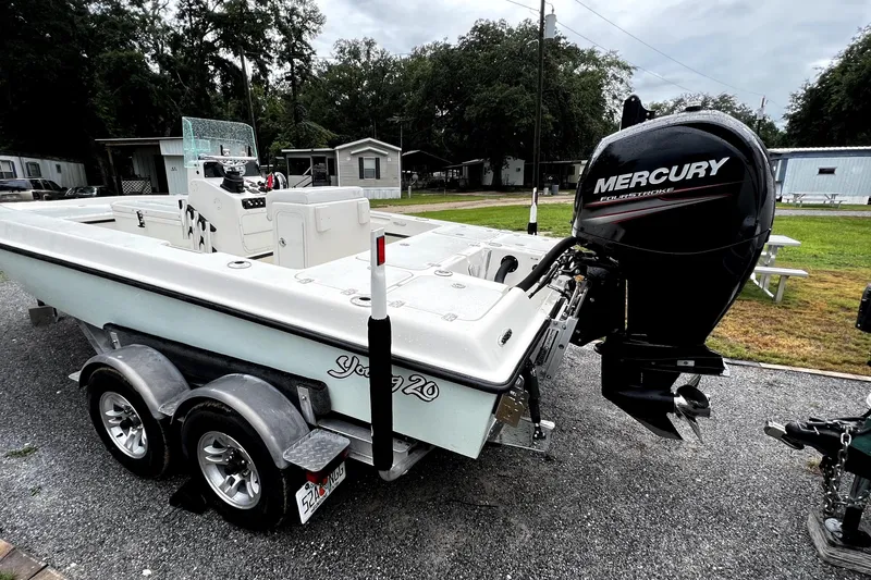 Slide: The Image of 2014 Young Boats 20 Bay Boat with Mercury FourStroke engine and green canopy. - 2