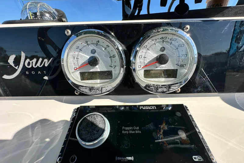 Slide: The Image of Dashboard of a 2014 Young Boats 20 bay boat with gauges and stereo display. - 22