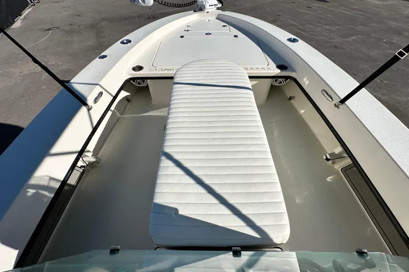 Slide: The Image of 2014 Young Boats 20 Bay Boat interior with white cushioned seating and storage compartments. - 27