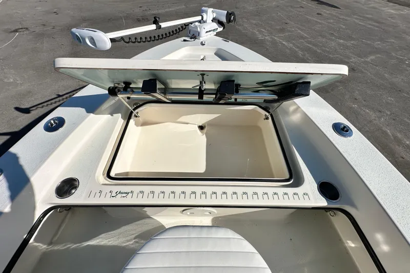 Slide: The Image of 2014 Young Boats 20 Bay Boat with open storage compartment and measuring scale. - 30