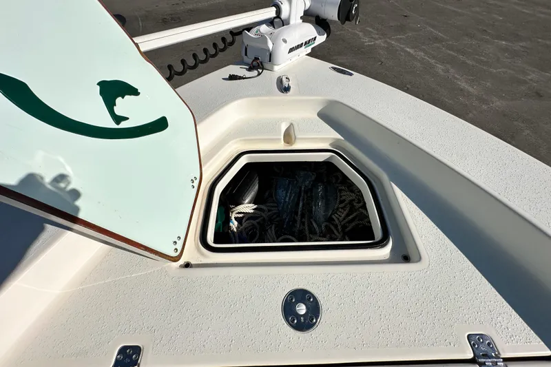 Slide: The Image of 2014 Young Boats 20 Bay Boat with open storage compartment and trolling motor. - 33