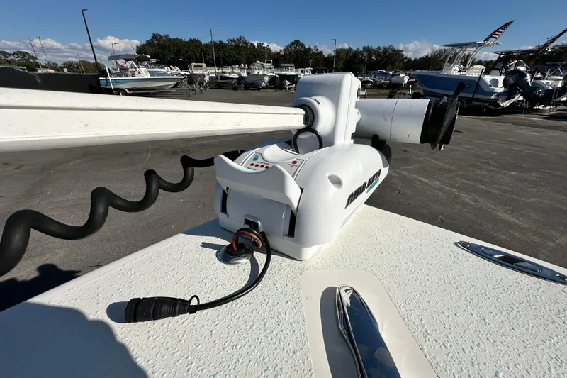 Slide: The Image of 2014 Young Boats 20 Bay Boat with trolling motor in a marina setting. - 35
