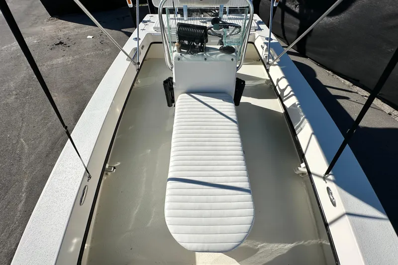 Slide: The Image of 2014 Young Boats 20 Bay Boat interior with white seating and steering console. - 39