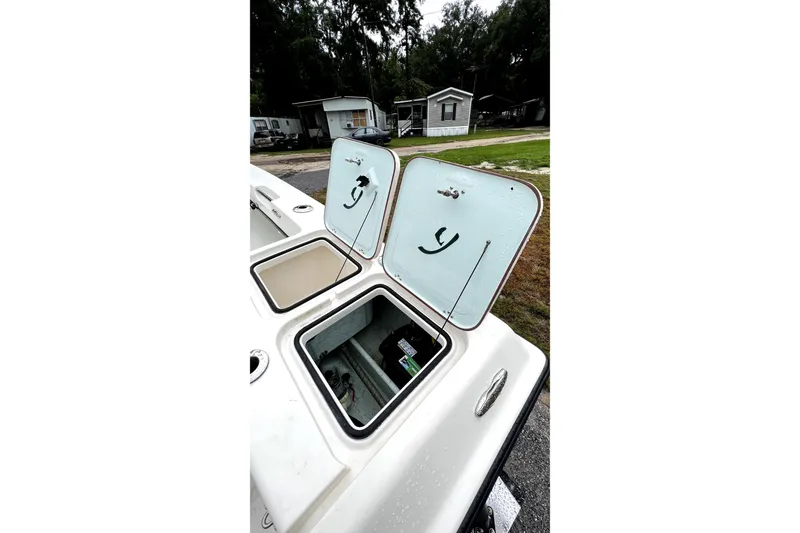 Slide: The Image of 2014 Young Boats 20 Bay Boat rear view with propeller and trailer on pavement. - 4