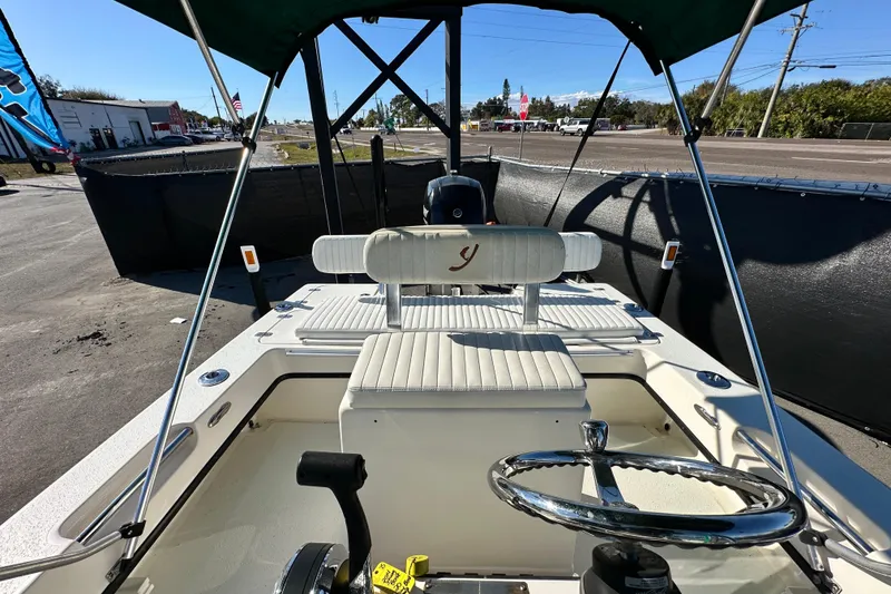 Slide: The Image of 2014 Young Boats 20 Bay Boat interior with steering wheel and seating. - 41