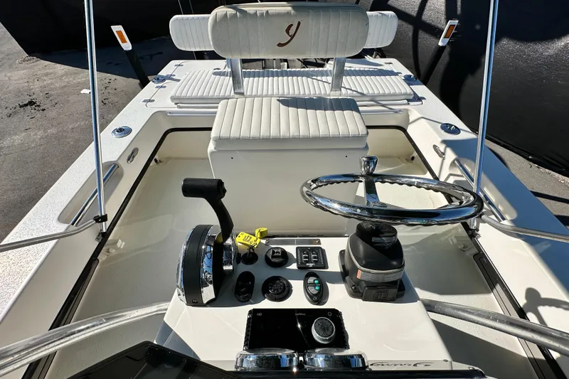 Slide: The Image of 2014 Young Boats 20 Bay Boat cockpit with steering wheel and controls. - 42