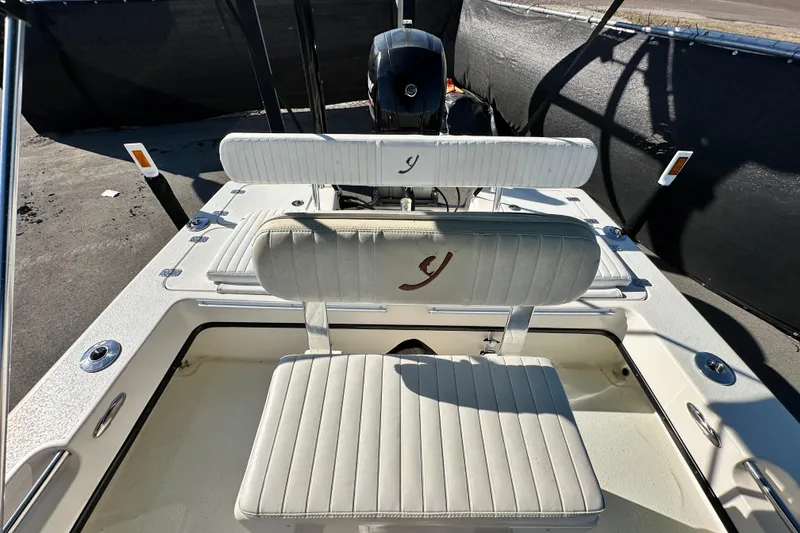 Slide: The Image of 2014 Young Boats 20 Bay Boat with white cushioned seating and motor. - 44