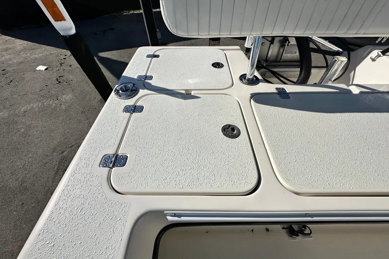 Slide: The Image of 2014 Young Boats 20 Bay Boat deck with storage compartments and textured surface. - 48