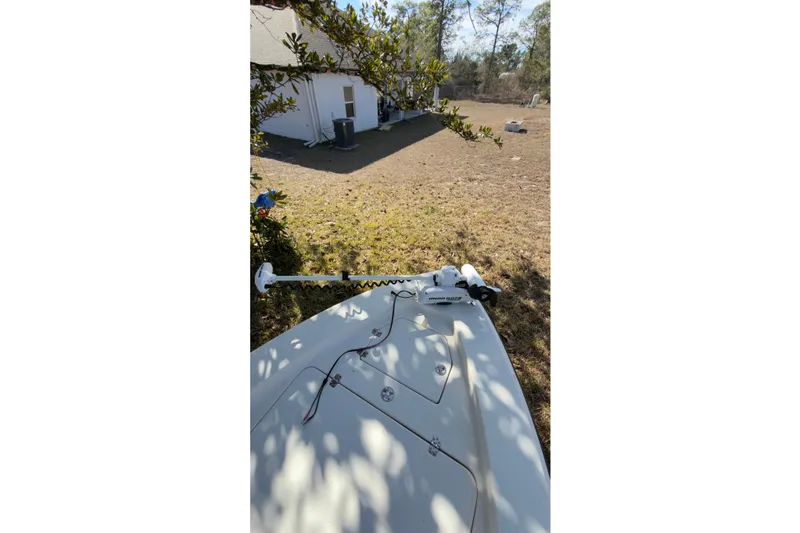 Slide: The Image of 2014 Young Boats 20 Bay Boat with Mercury engine and green canopy on trailer. - 5