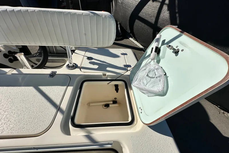 Slide: The Image of 2014 Young Boats 20 Bay Boat interior with open storage compartment and seating. - 53