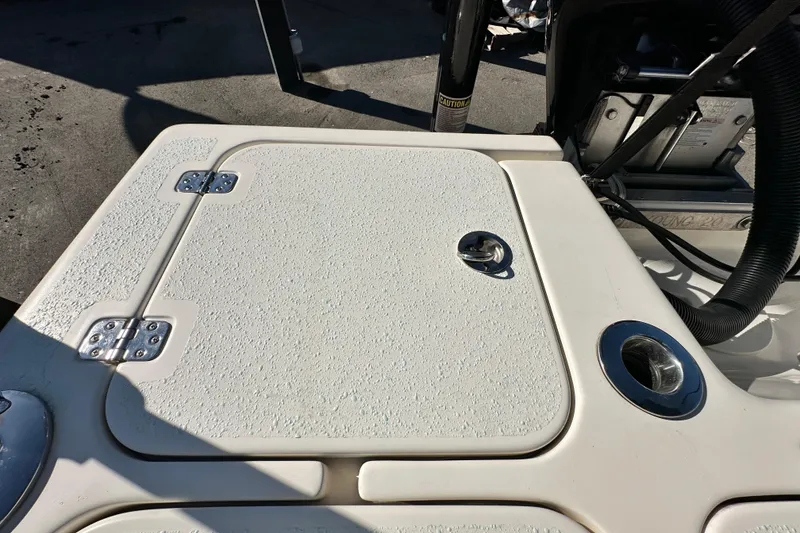 Slide: The Image of 2014 Young Boats 20 Bay Boat deck with storage hatch and hardware. - 54