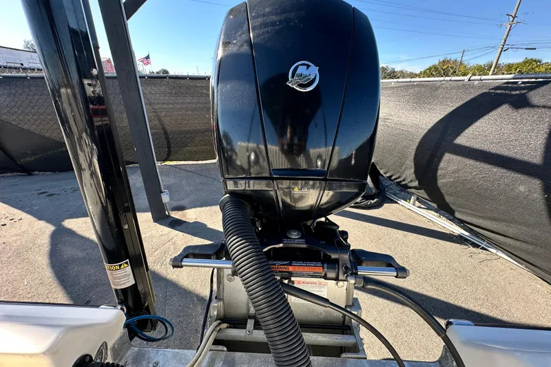 Slide: The Image of 2014 Young Boats 20 Bay Boat with powerful outboard motor in a sunny outdoor setting. - 59