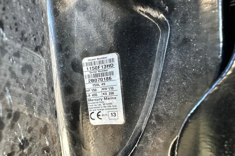 Slide: The Image of 2014 Young Boats 20 Bay Boat with Mercury engine, docked under clear blue sky. - 62