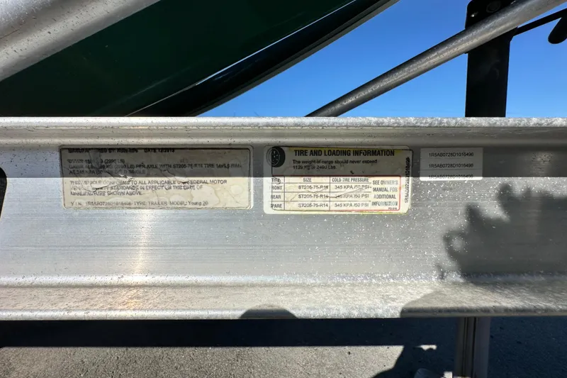 Slide: The Image of 2014 Young Boats 20 Bay Boat trailer label with tire and loading information. - 67