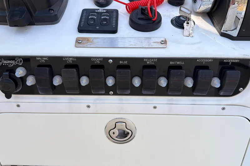 Slide: The Image of 2014 Young Boats 20 Bay Boat with canopy, parked outdoors under clear blue sky. - 9