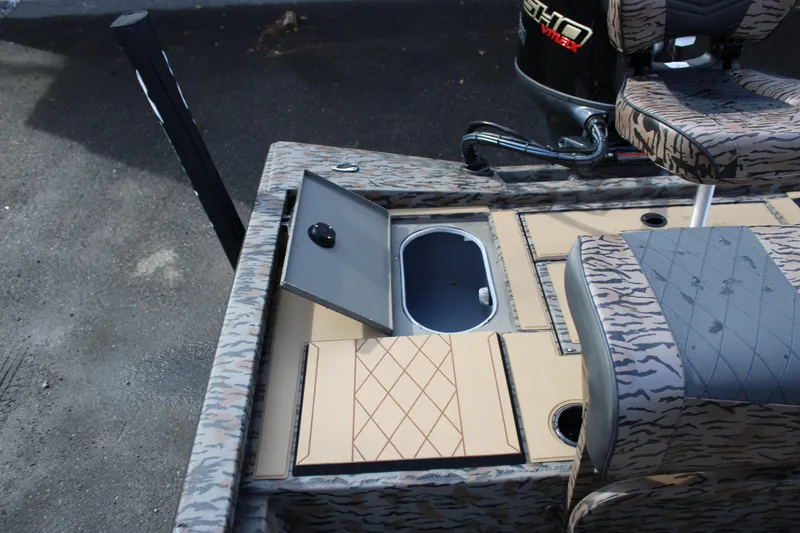 Slide: The Image of 2026 Xpress H190B Bay boat interior with open storage compartment and patterned seating. - 10