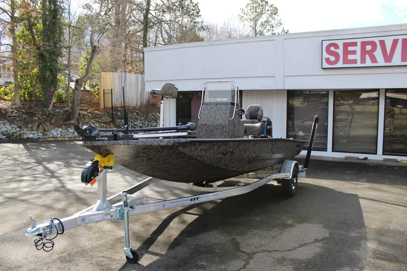 Slide: The Image of 2026 Xpress H190B Bay boat on trailer outside service center. - 3
