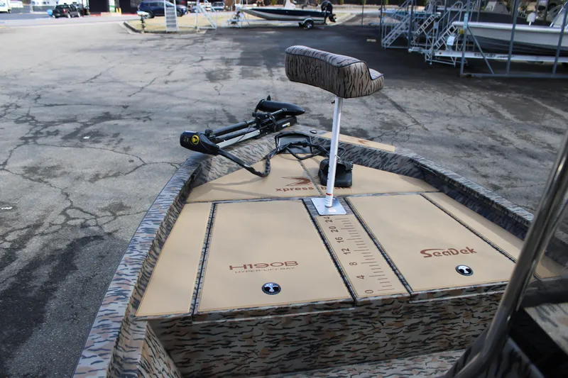 Slide: The Image of 2026 Xpress H190B Bay boat with SeaDek flooring in a parking lot. - 4