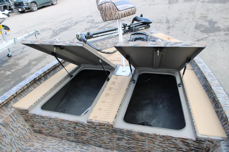 Slide: The Image of 2026 Xpress H190B Bay boat with open storage compartments and camouflage design. - 5