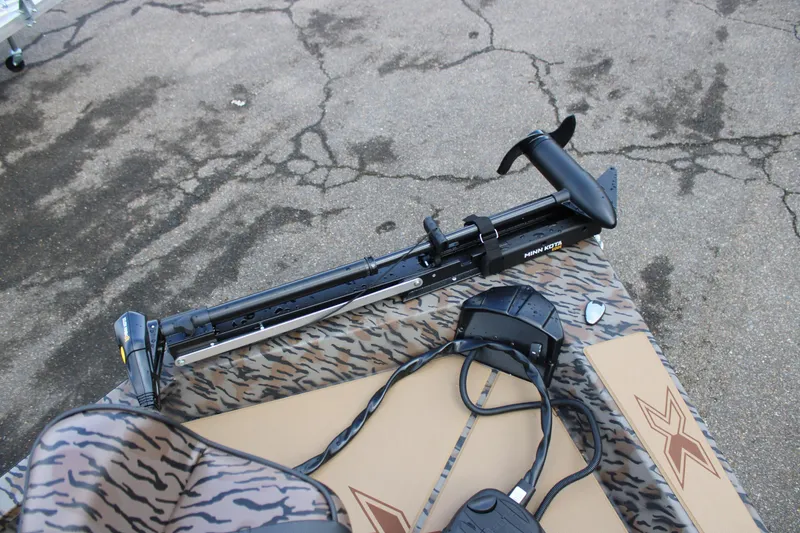 Slide: The Image of 2026 Xpress H190B Bay boat with Minn Kota trolling motor on patterned deck. - 6