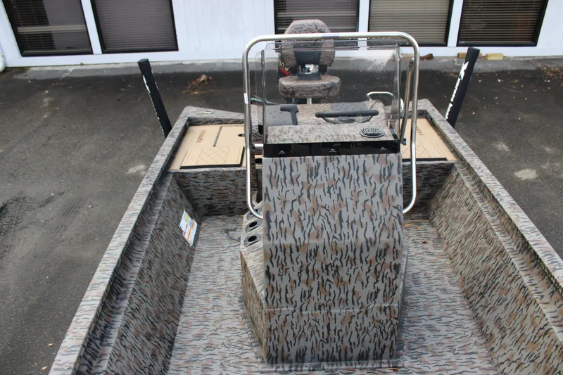 Slide: The Image of 2026 Xpress H190B Bay boat interior with camouflage design and central console. - 7