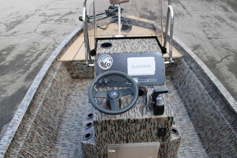 Slide: The Image of 2026 Xpress H190B Bay boat interior with Garmin navigation system and camo design. - 8