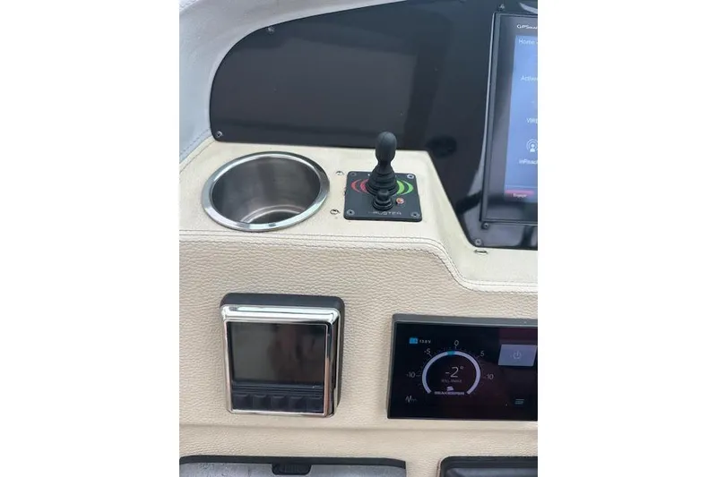 Slide: The Image of 2019 Regal 33 OBX boat dashboard with joystick control and digital displays. - 11