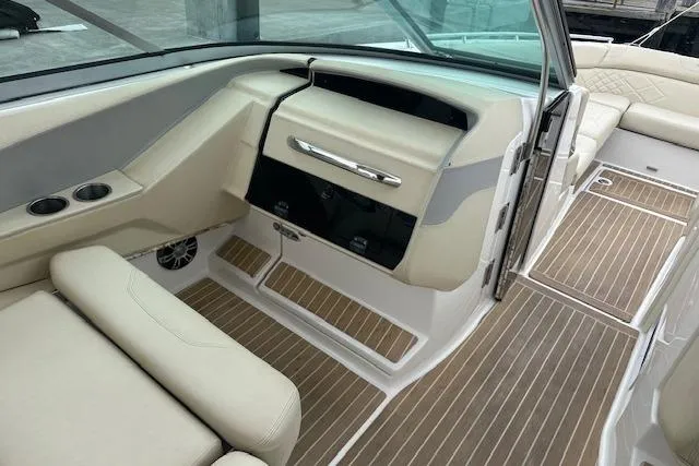 Slide: The Image of 2019 Regal 33 OBX boat interior with beige seating and wood-patterned flooring. - 14