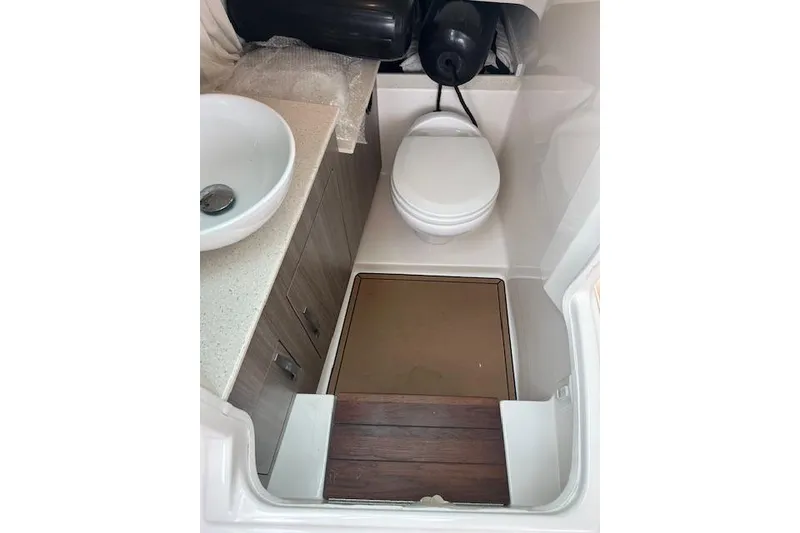 Slide: The Image of 2019 Regal 33 OBX boat bathroom with sink and toilet. - 15