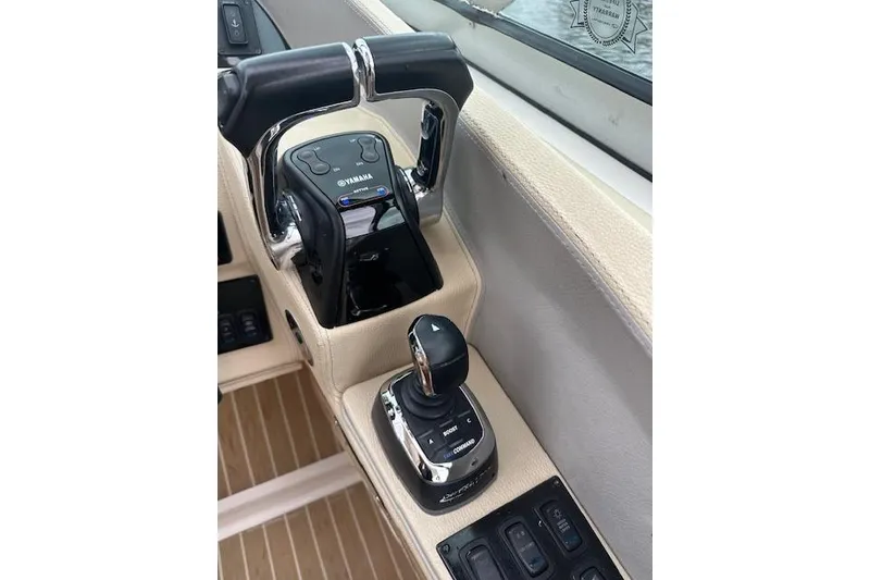 Slide: The Image of 2019 Regal 33 OBX boat controls featuring Yamaha throttle and joystick. - 16