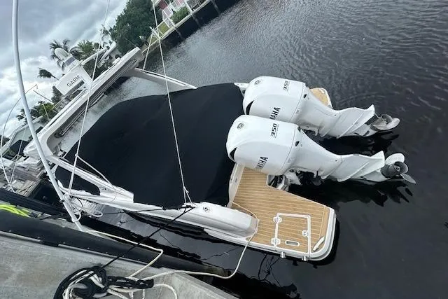 Slide: The Image of 2019 Regal 33 OBX boat with twin Yamaha outboard engines docked in a marina. - 2