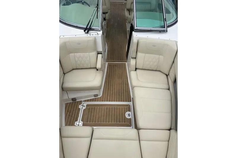 Slide: The Image of 2019 Regal 33 OBX boat interior with beige seating and wooden flooring. - 20