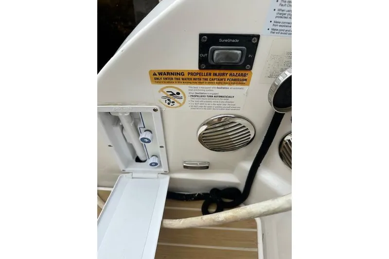 Slide: The Image of 2019 Regal 33 OBX boat control panel with safety warning and SureShade button. - 22