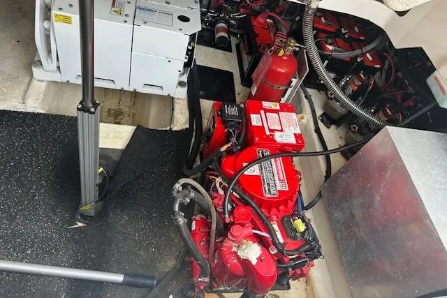 Slide: The Image of Engine compartment of a 2019 Regal 33 OBX boat, featuring red machinery and equipment. - 25