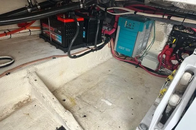 Slide: The Image of 2019 Regal 33 OBX boat engine compartment with batteries and wiring. - 26