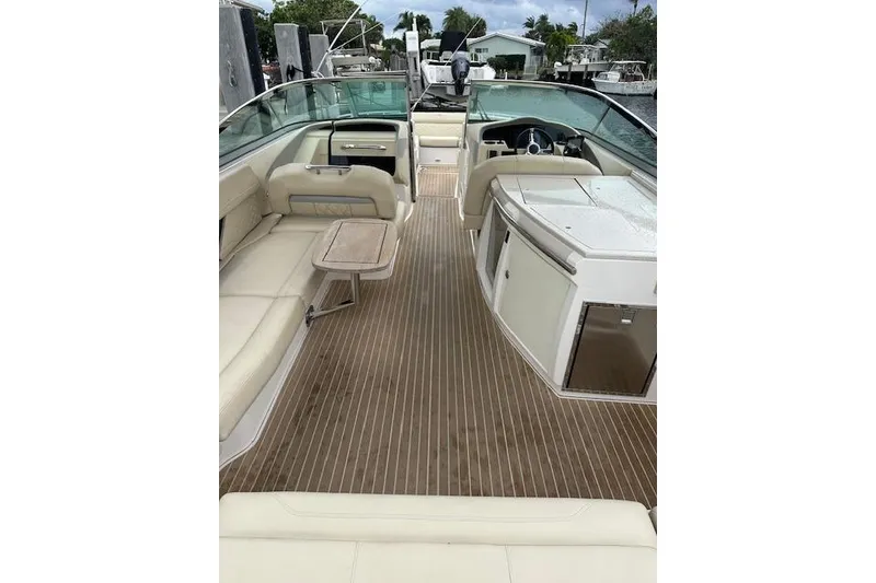 Slide: The Image of 2019 Regal 33 OBX boat interior with beige seating and wooden flooring. - 30