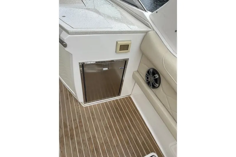 Slide: The Image of 2019 Regal 33 OBX boat interior with wood flooring and built-in speaker. - 35