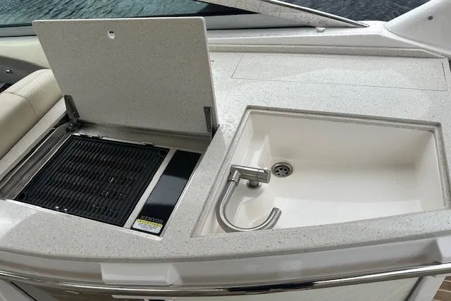 Slide: The Image of 2019 Regal 33 OBX boat with built-in grill and sink on deck. - 37