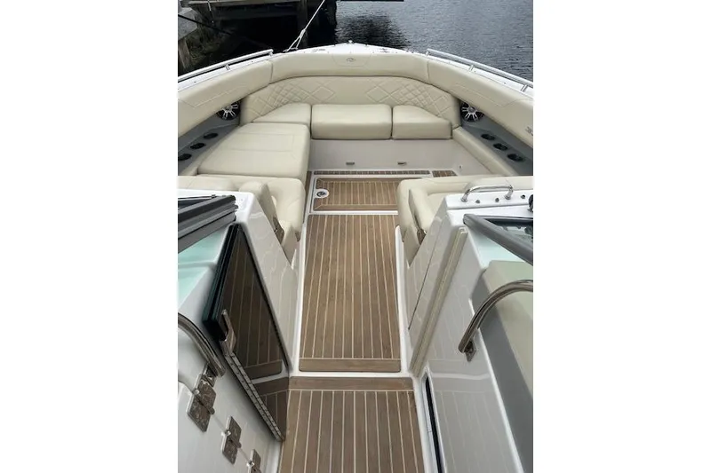 Slide: The Image of 2019 Regal 33 OBX boat interior with beige seating and wooden flooring. - 41