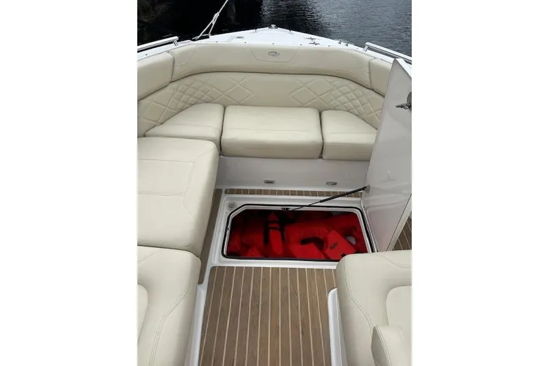 Slide: The Image of 2019 Regal 33 OBX boat interior with open storage compartment and cushioned seating. - 42