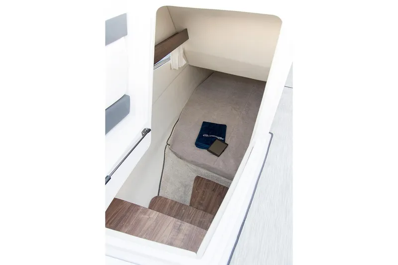 Slide: The Image of Manufacturer Provided Image: 2019 Regal 33 OBX cabin interior with bed and wooden steps. - 7