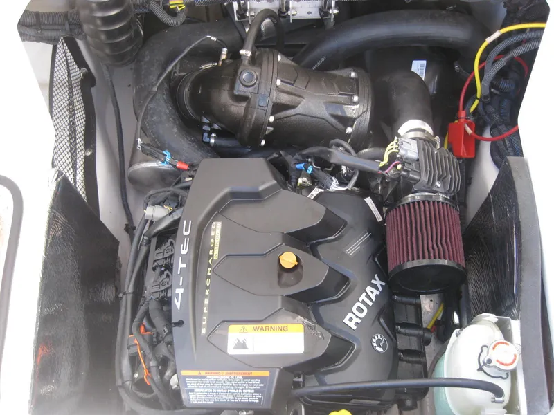 Slide: The Image of Engine compartment of a 2016 Scarab 195 HO Impulse boat featuring a Rotax 4-TEC engine. - 11