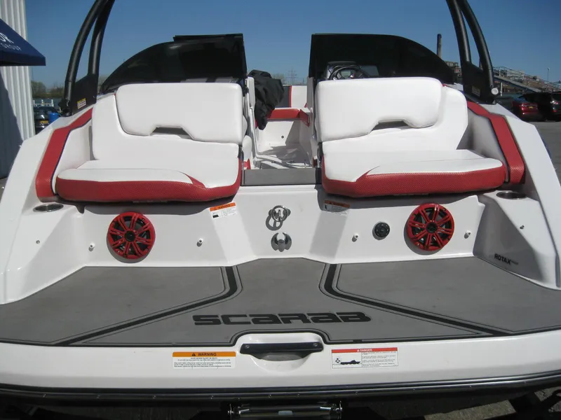 Slide: The Image of 2016 Scarab 195 HO Impulse boat with red and white seating and rear speakers. - 12