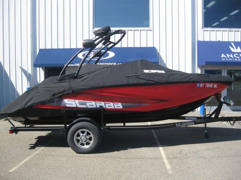 Slide: The Image of 2016 Scarab 195 HO Impulse boat with cover on trailer. - 15