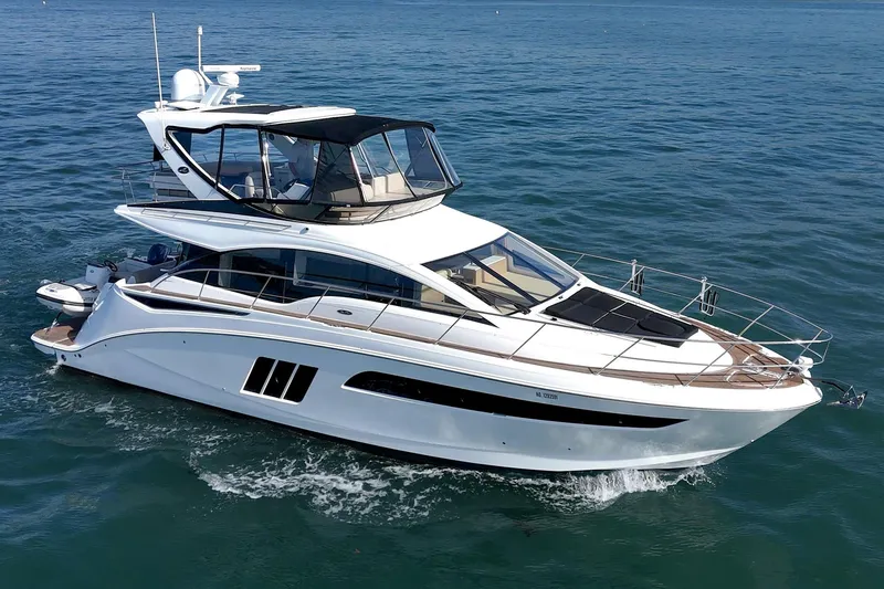 Slide: The Image of 2018 Sea Ray Fly 510 yacht cruising on open water. - 10