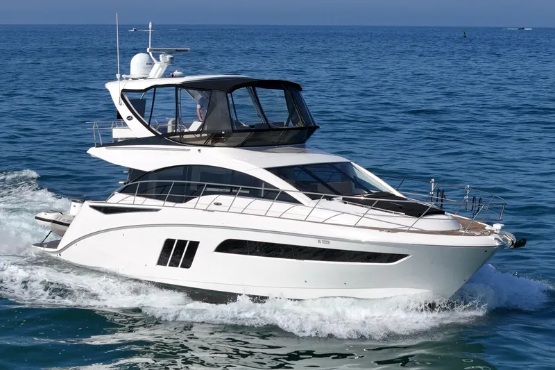 Slide: The Image of 2018 Sea Ray Fly 510 yacht cruising on open water. - 11