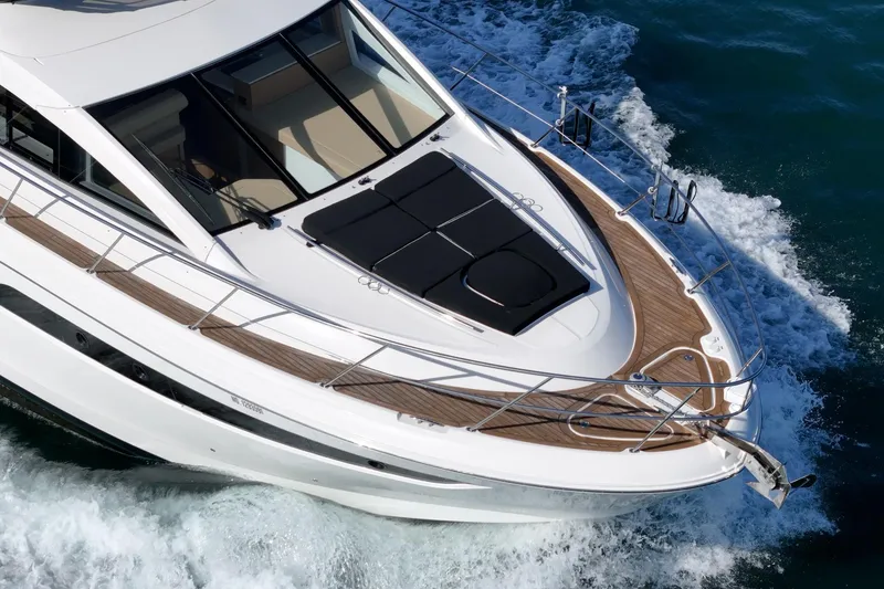 Slide: The Image of 2018 Sea Ray Fly 510 yacht cruising on open water, showcasing sleek design and luxury features. - 13