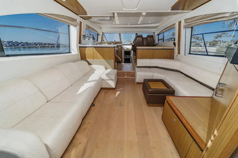 Slide: The Image of Luxurious interior of 2018 Sea Ray Fly 510 yacht with spacious seating and panoramic windows. - 17