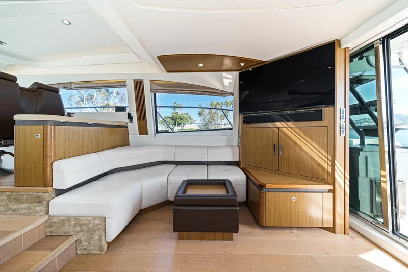 Slide: The Image of Luxurious interior of 2018 Sea Ray Fly 510 yacht with modern seating and wood accents. - 18