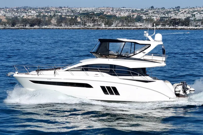 Slide: The Image of 2018 Sea Ray Fly 510 yacht cruising on blue ocean waters. - 2